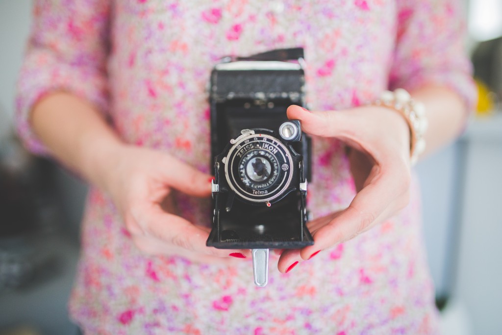 kaboompics.com_Old analog camera in woman's hands