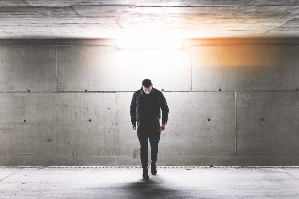 young-man-walking-in-conrete-underground-walkway-picjumbo-com