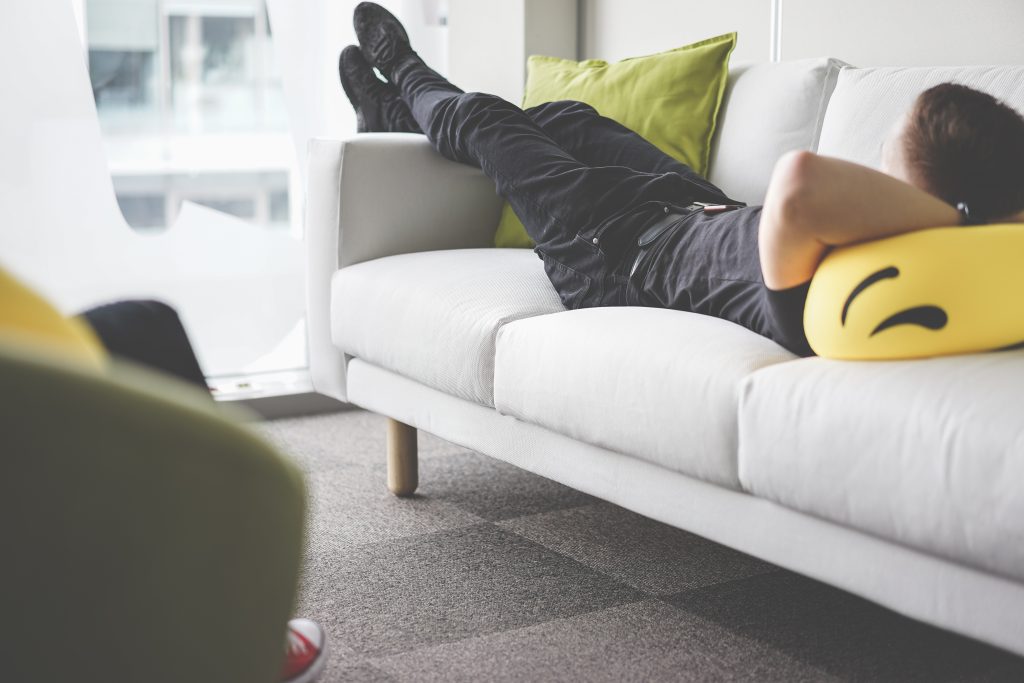young-man-napping-on-white-sofa-in-the-office-picjumbo-com